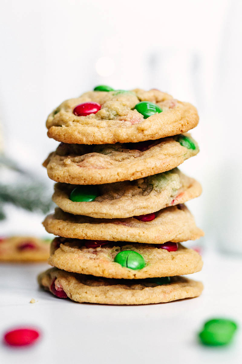 six m&m Christmas pudding cookies stacked on a table