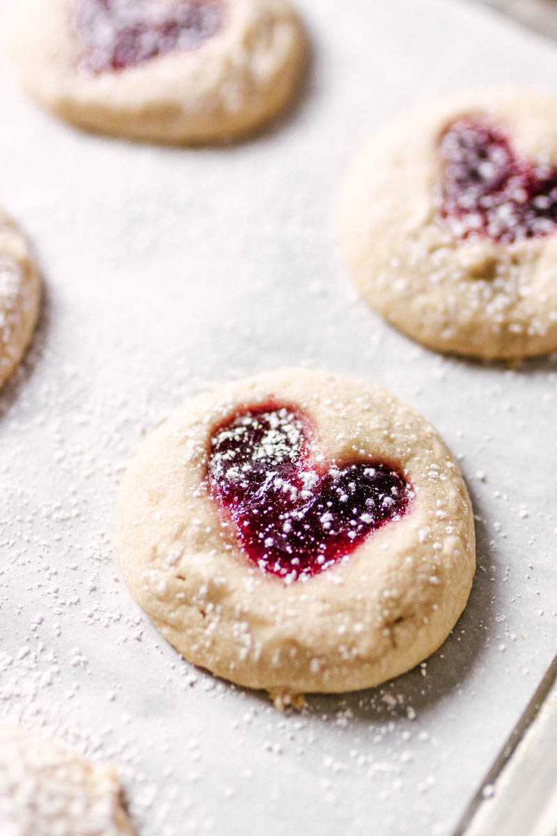 Heart thumbprint cookie on a baking sheet