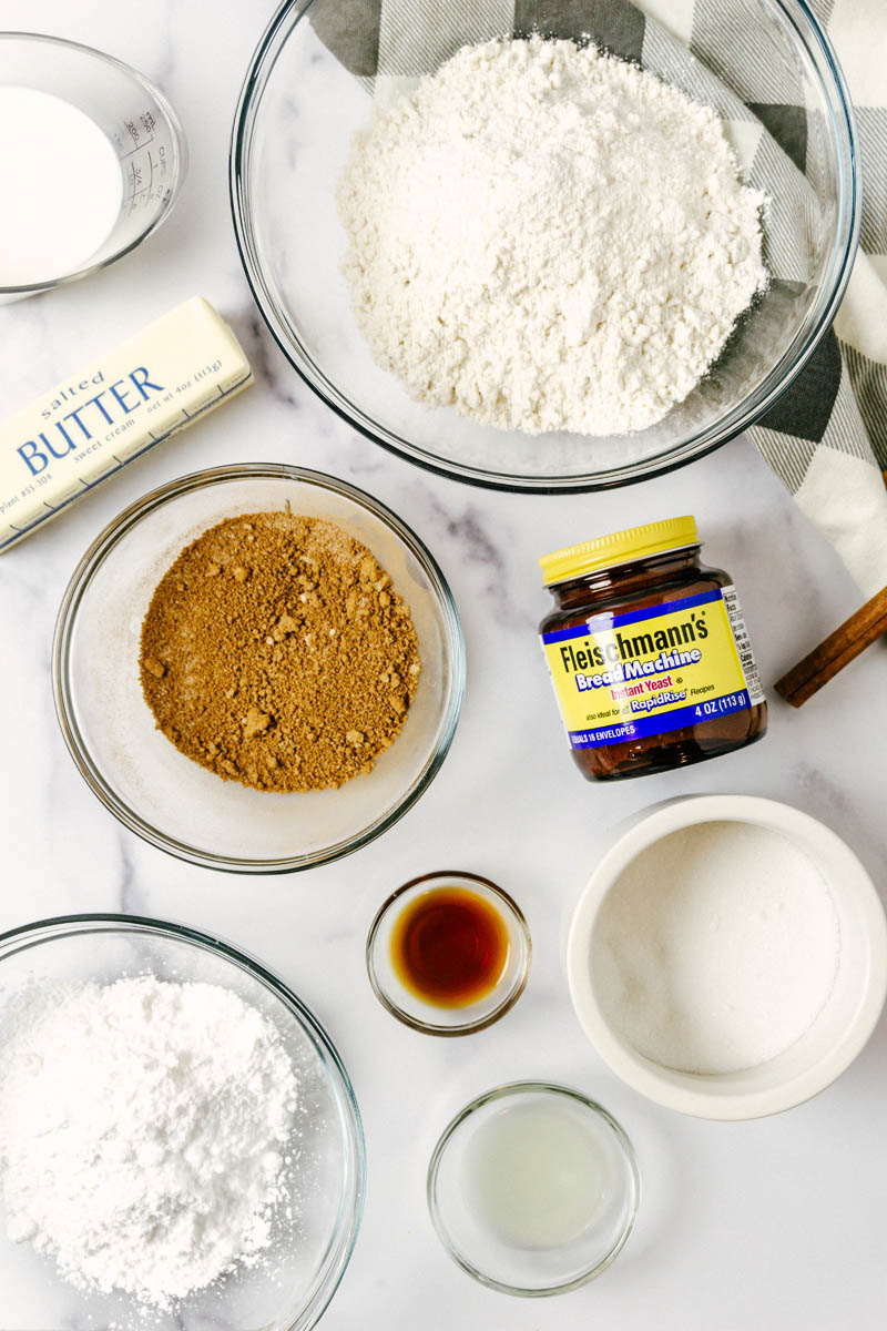 ingredients for the small batch cinnamon rolls spread out on the table in bowls