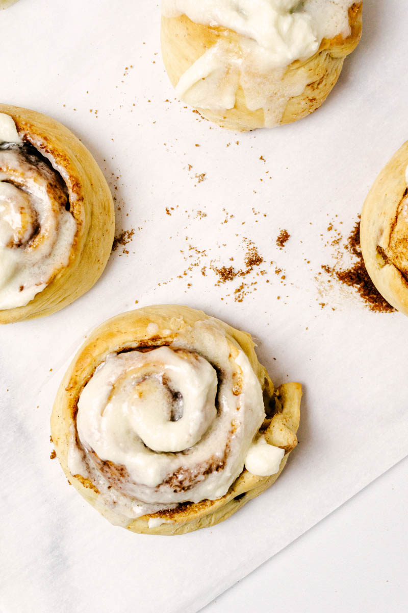 4 cinnamon rolls on parchment paper