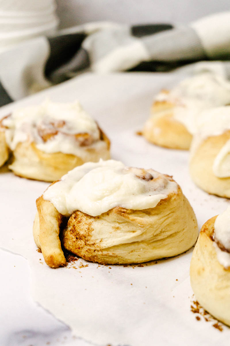 up-close of cinnamon rolls on parchment paper